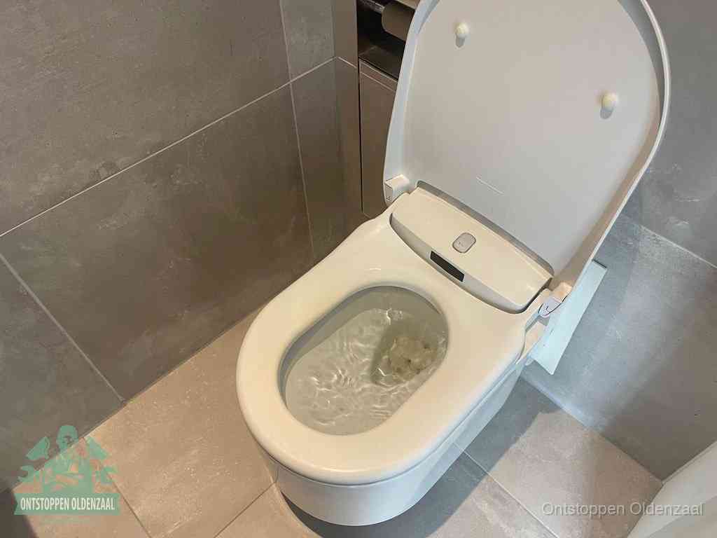 Een toiletpot vol troebel water met drijvend papier en restanten, de meest voorkomende oorzaak van een verstopte wc in Oldenzaal